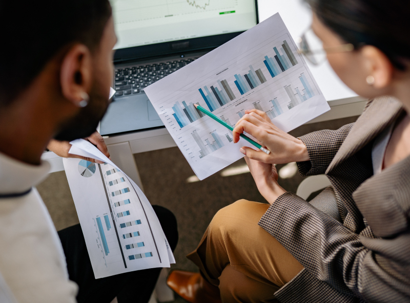 Two people reviewing digital marketing analytics.