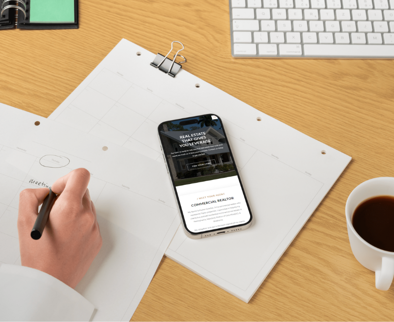 hand writing on papers with phone laying close.