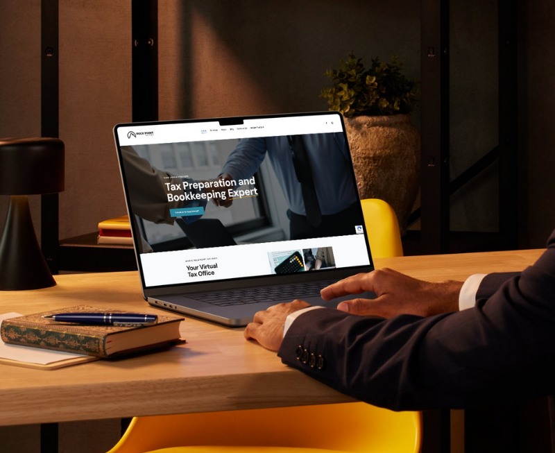 Person on a laptop looking at the Rock Point Tax Prep Website